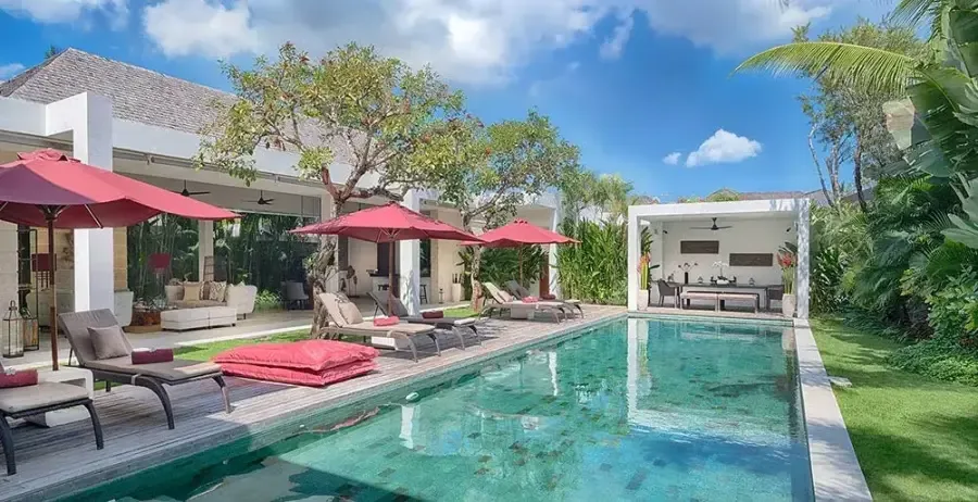 Private villa in Bali with turquoise pool and red umbrellas